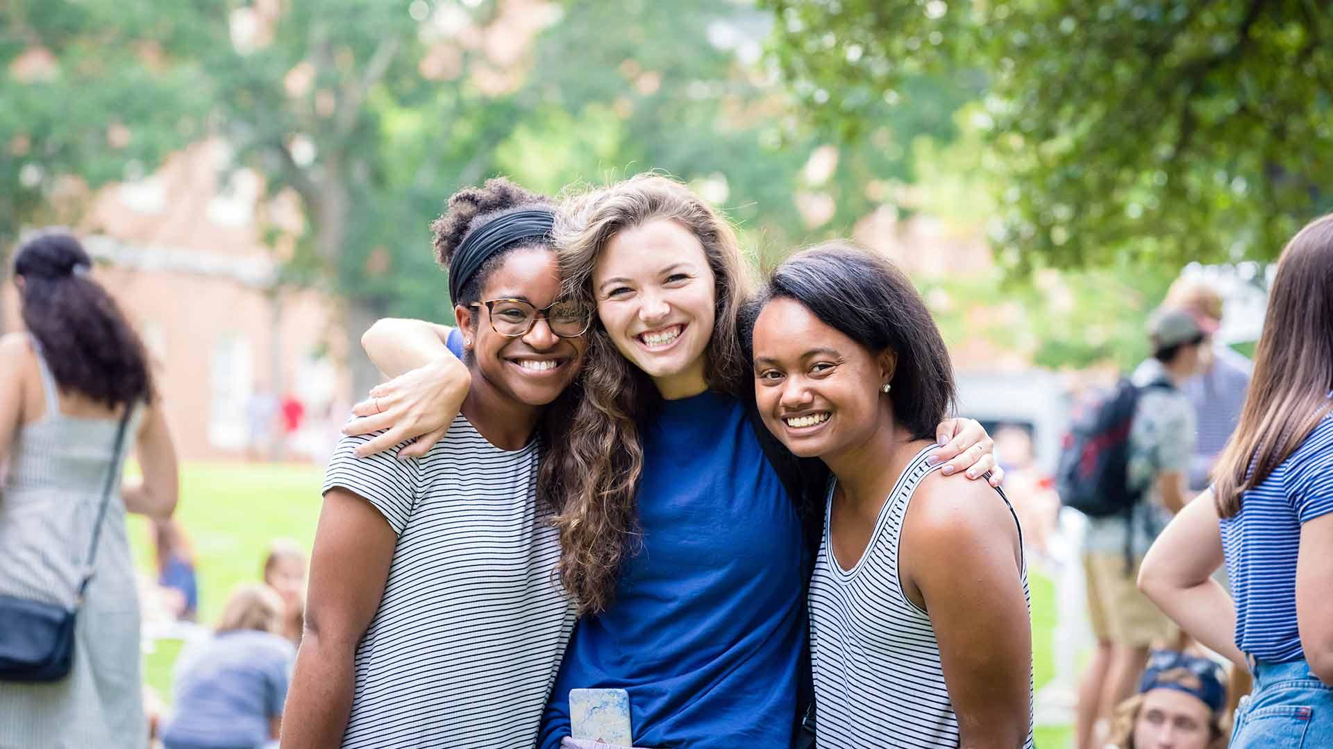 three female students hugging
